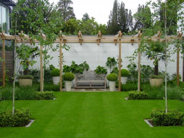 amazing-simple-home-garden-design-with-grass-bushes-and-small-trees-plus-canopy-and-wood-bench